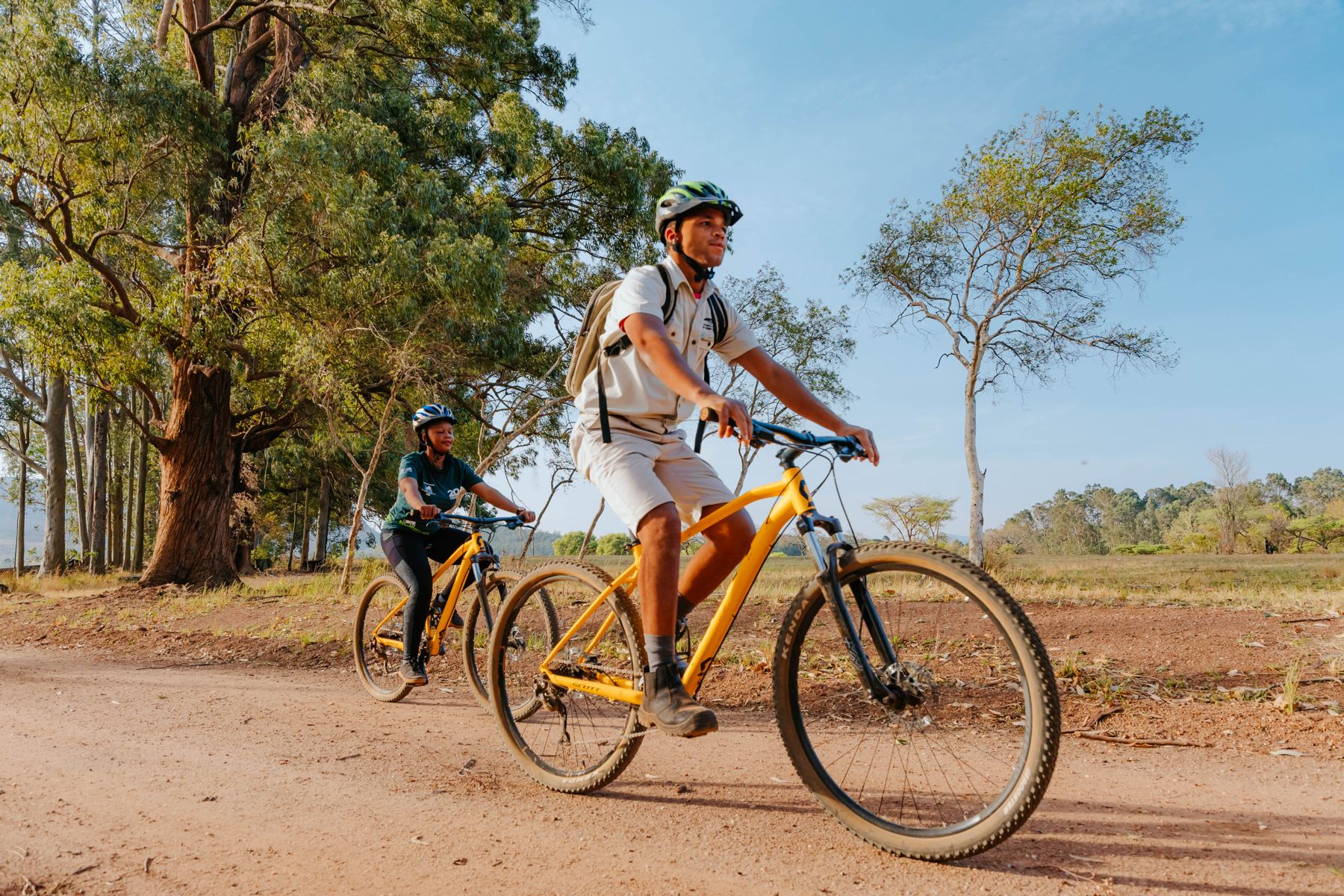 Mountain bikers on a red dirt road