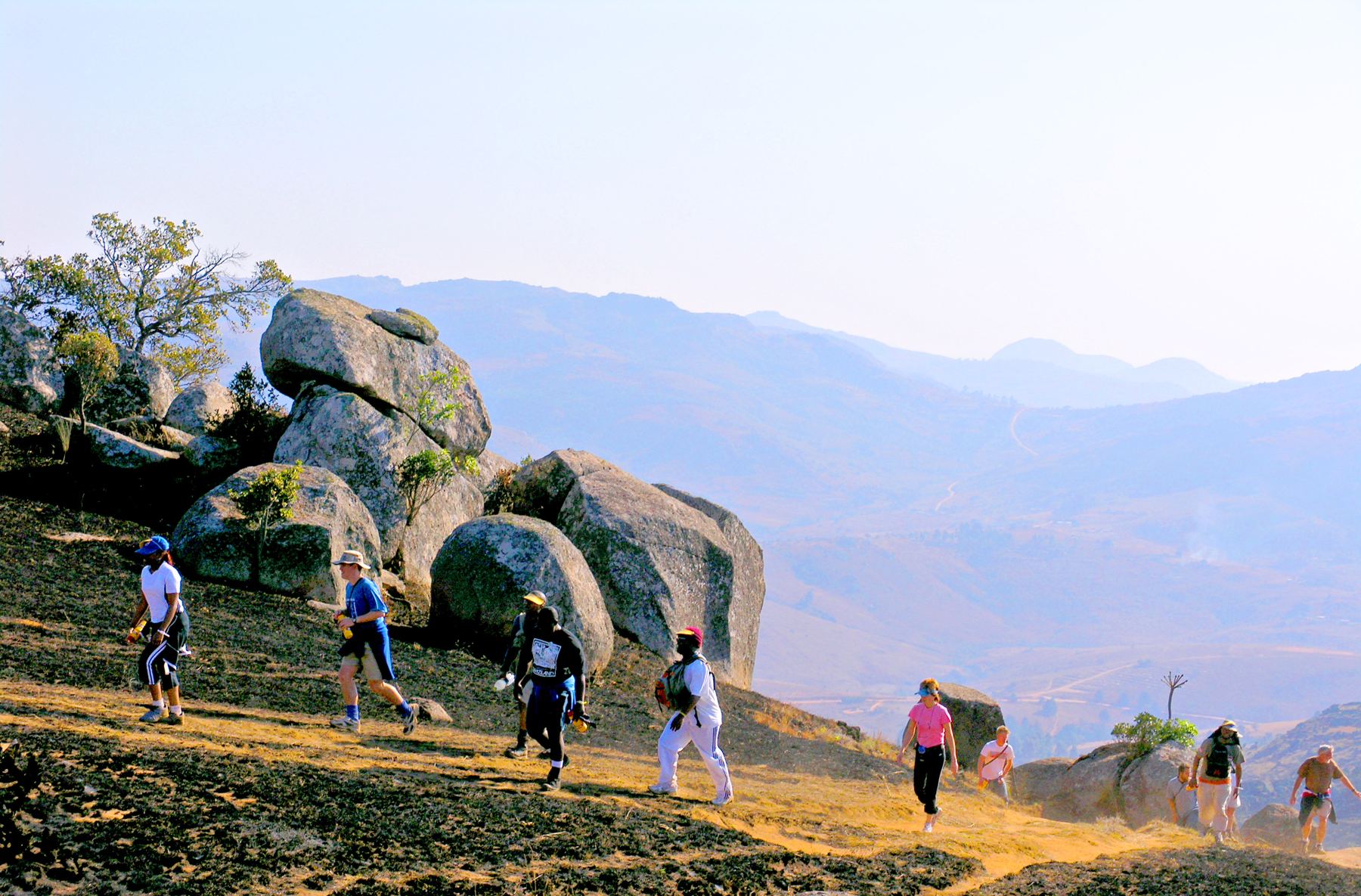 Hikers among granite boulders above the valley
