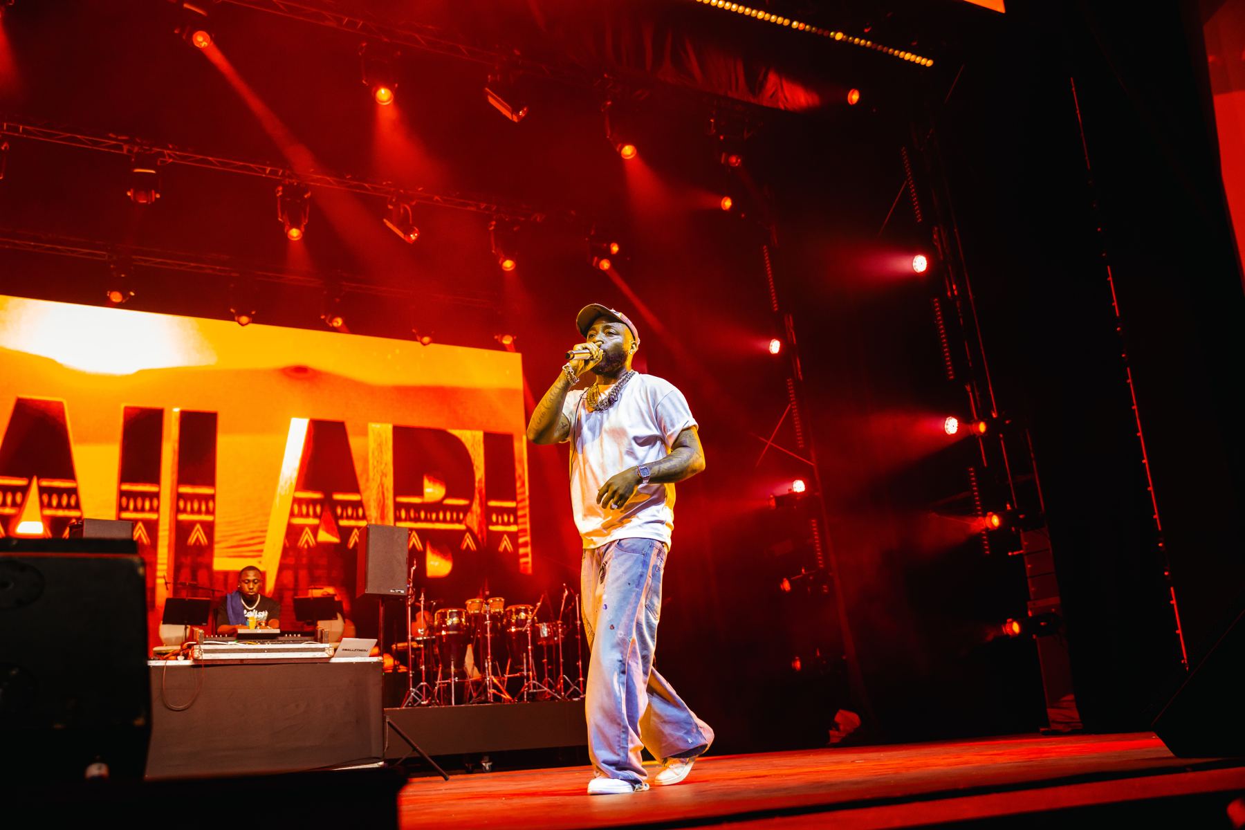 Performer on stage under red lights