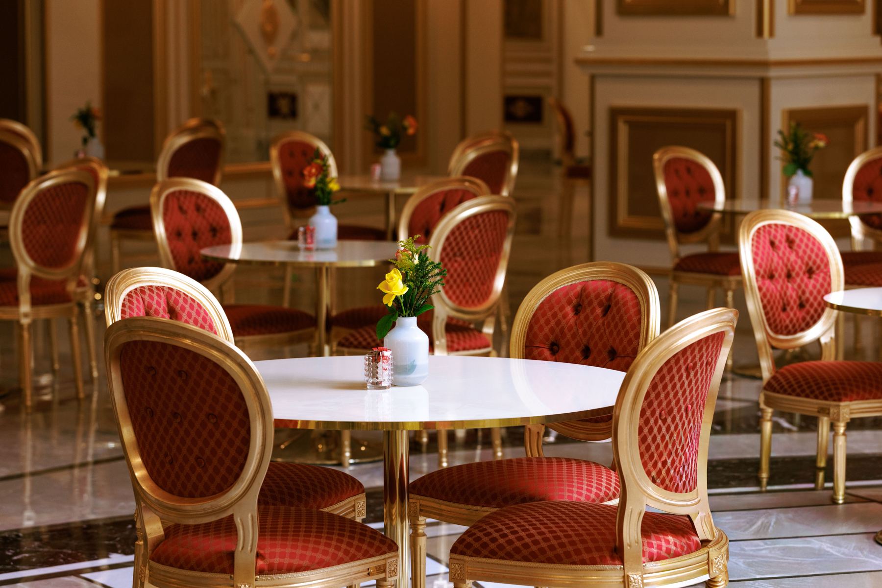 Gilded café with red velvet chairs